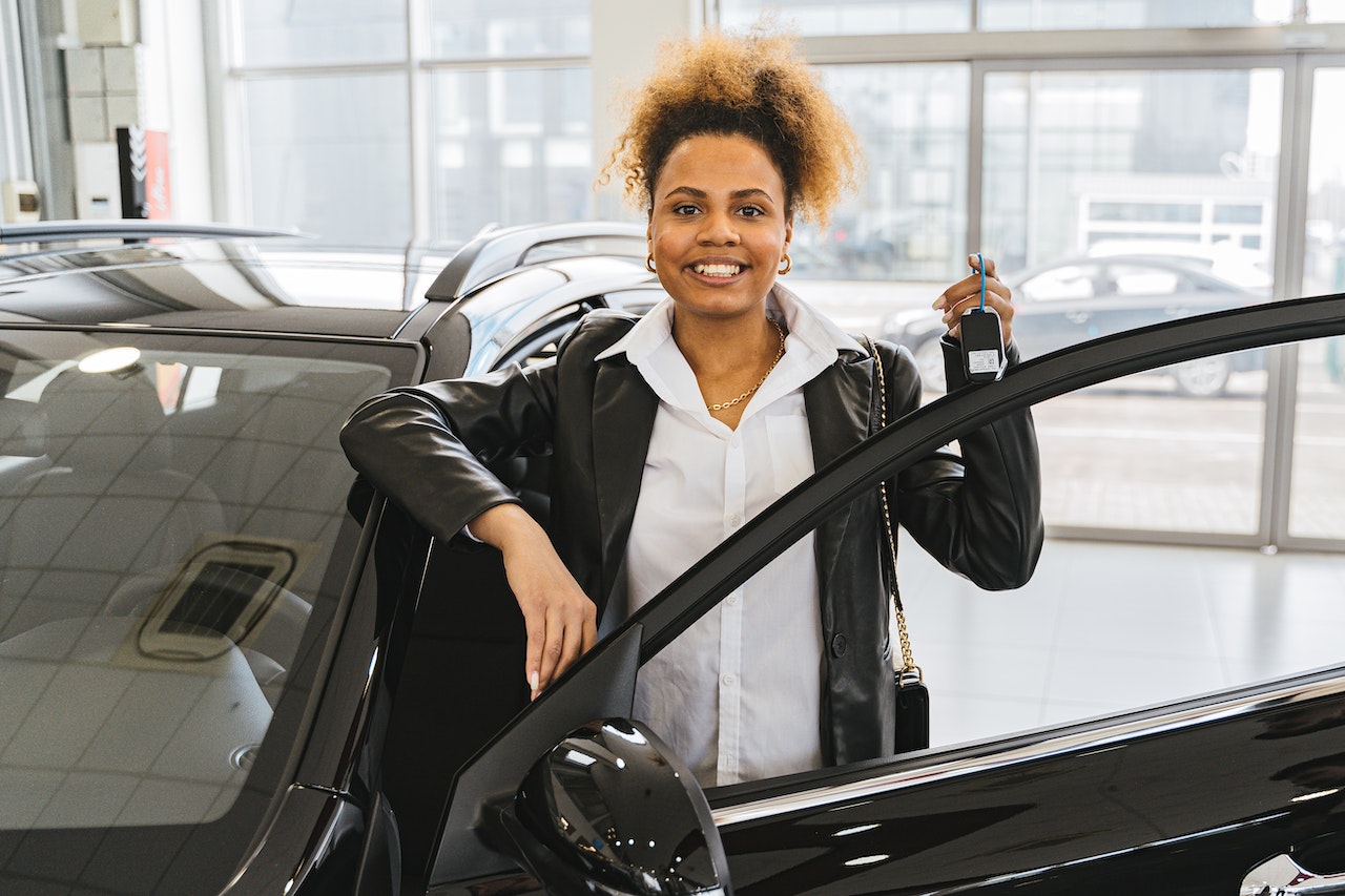 Woman in Black Blazer Holding Car Keys Smiling