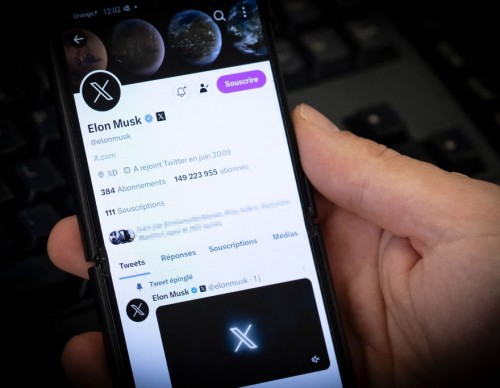 Elon Musk X.com on phone