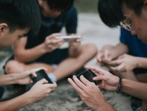 Teenage Boys Playing Mobile Games