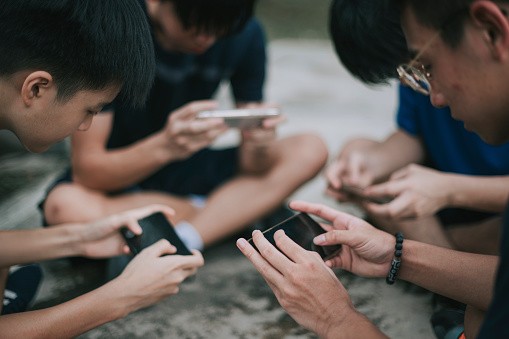 Teenage Boys Playing Mobile Games