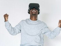 A Happy Man in Gray Sweater Enjoying the VR Headset he is Wearing