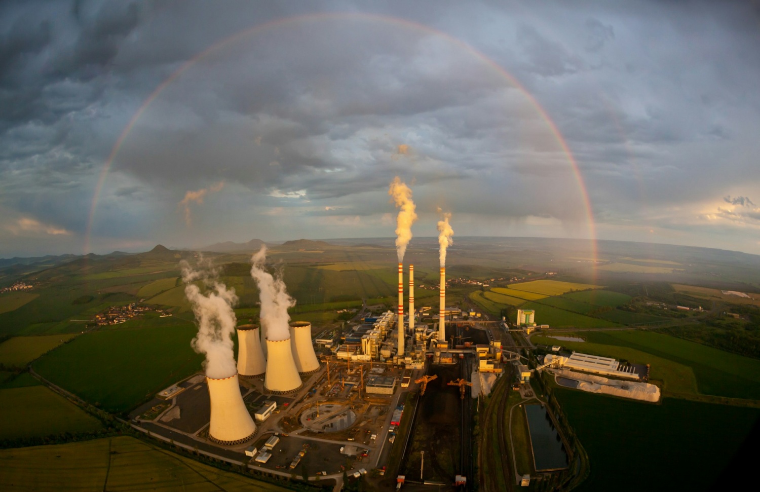 Power plant, chimney, rainbow