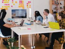 five person by table watching turned on white iMac