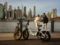 a man and a woman standing next to a bike