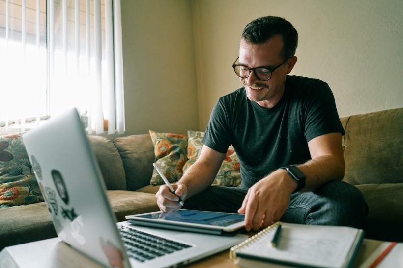 man in black crew neck t-shirt using macbook air