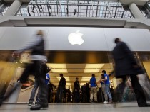 People walk by the Apple Store in the Eaton Centre shopping mall in Toronto, March 16, 2012. The new iPad went on sale on Friday in 10 countries, including the United States, Canada, Singapore, France and Britain.