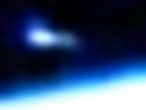 A blue tadpole-shaped glowing orb captured by ISS