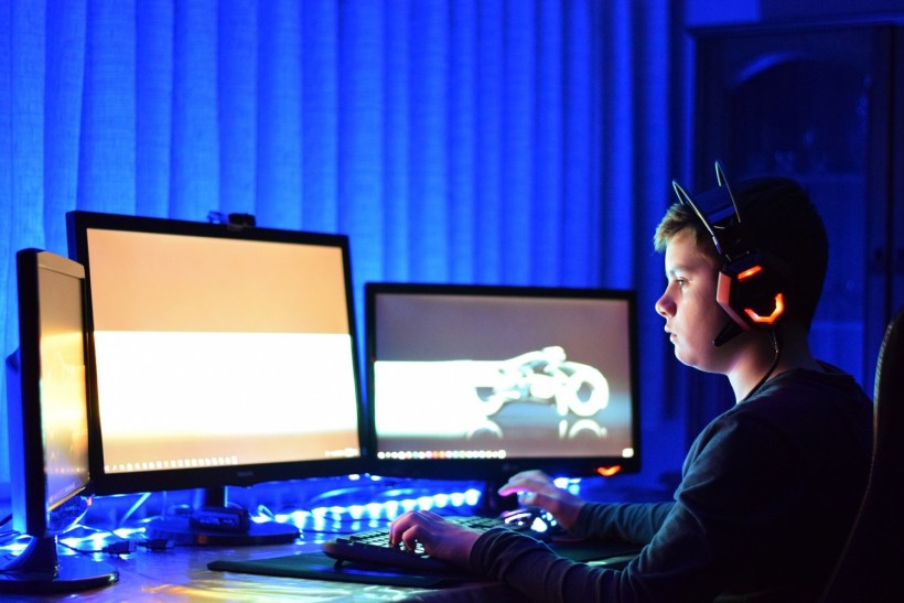 Man gaming with three monitors