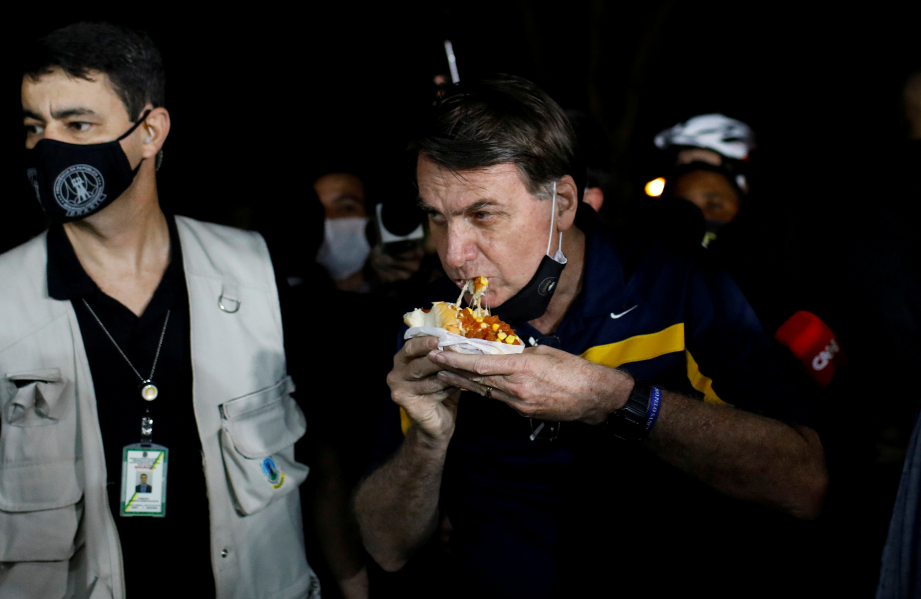 [VIDEO] Moment Brazil President was Jeered at and Called a 'Murder' as He Walked Up to Eat Hotdog Outside His Residence