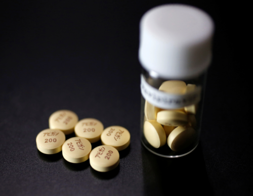 FILE PHOTO: Tablets of Avigan (generic name : Favipiravir), a drug approved as an anti-influenza drug in Japan and developed by drug maker Toyama Chemical Co, a subsidiary of Fujifilm Holdings Co. are displayed during a photo opportunity in Tokyo