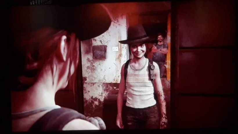 The Last of Us Part 2 Ellie making faces in the mirror while Joel watches her
