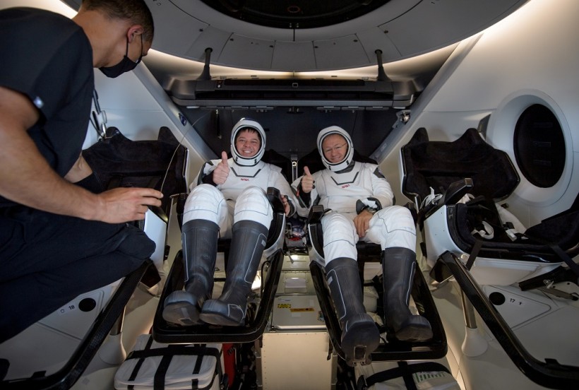 NASA astronauts Robert Behnken and Douglas Hurley inside SpaceX Crew Dragon Endeavour spacecraft onboard SpaceX GO Navigator recovery ship shortly after having landed in Gulf of Mexico off coast of Pensacola, Florida